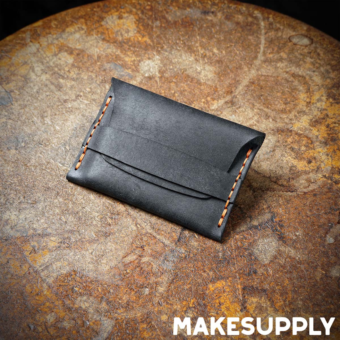 leather flap wallet made from black vegetable tanned leather with hand stitched edges