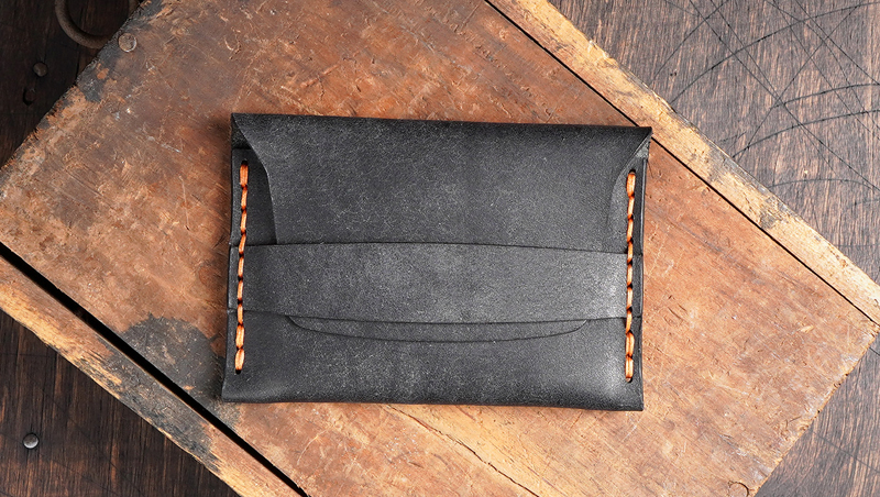 finished leather flap wallet with minimalist flap design and hand stitching