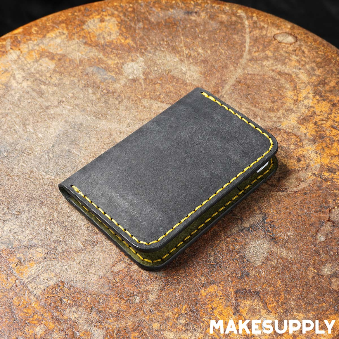 Closed vertical leather bifold wallet with hand stitching and slim profile