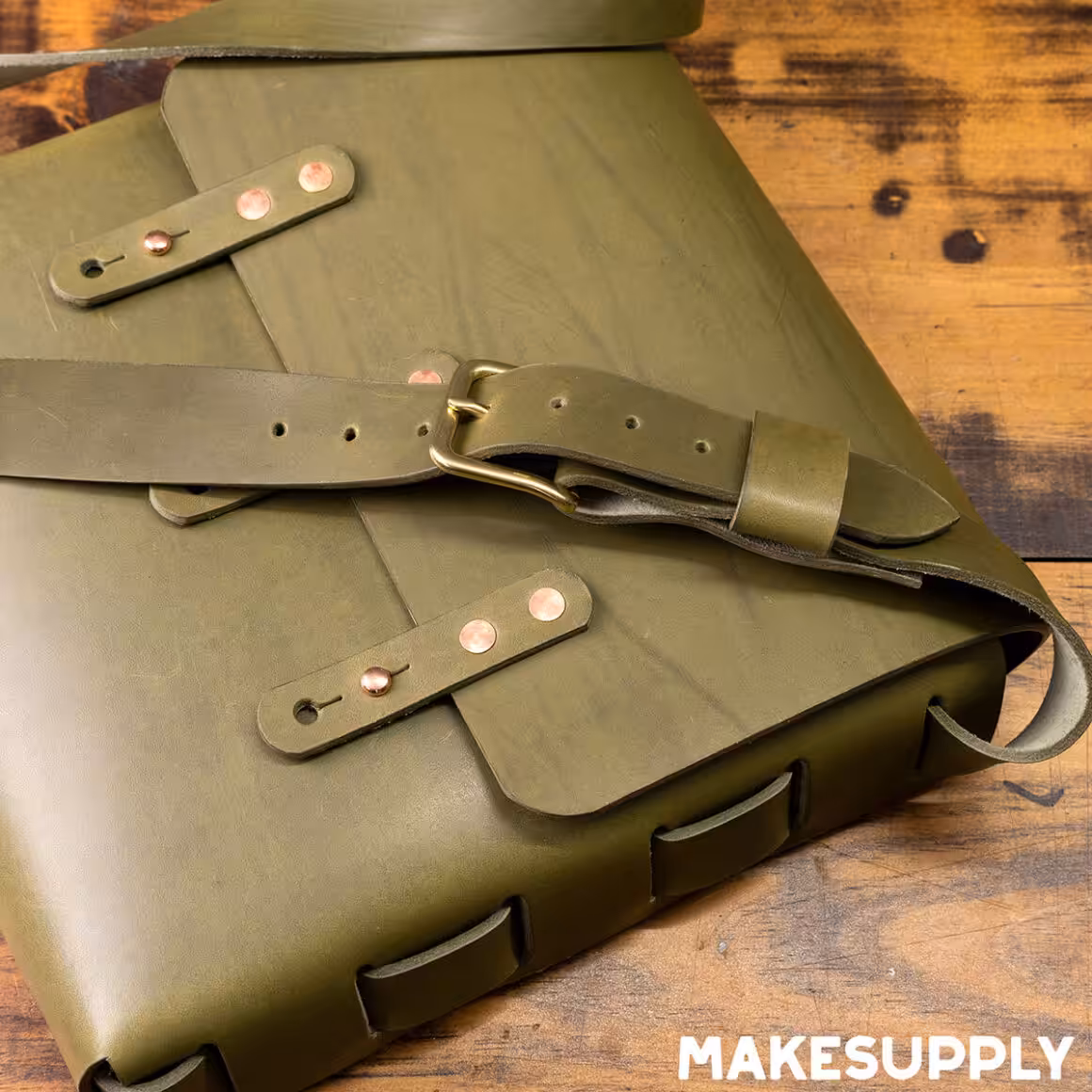 laced leather satchel with buckle closure made from green leather