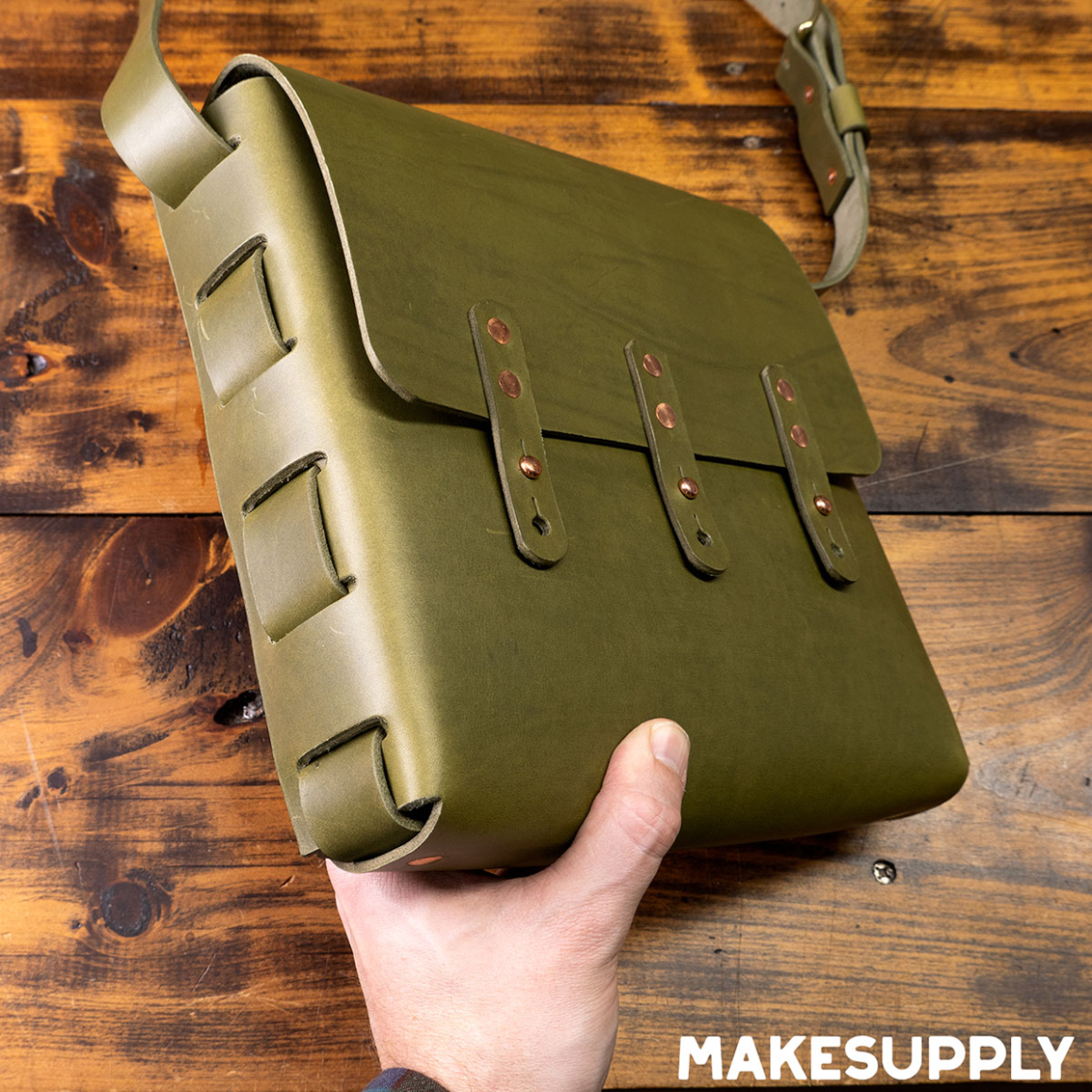 handmade laced leather satchel showing side lacing and front straps