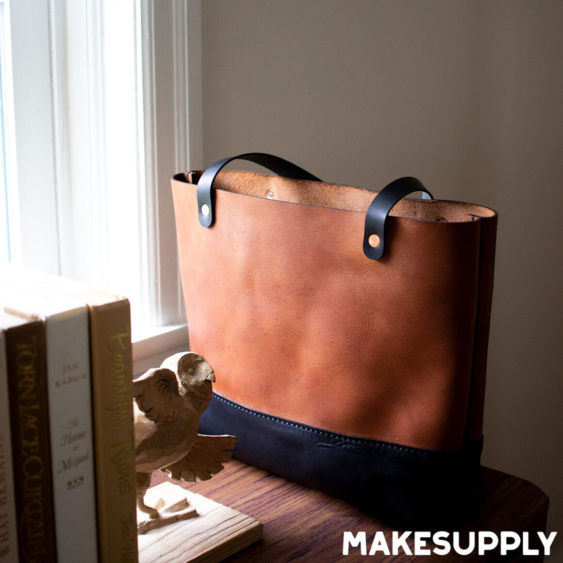 Handmade leather tote bag pattern with simple handles and structured body