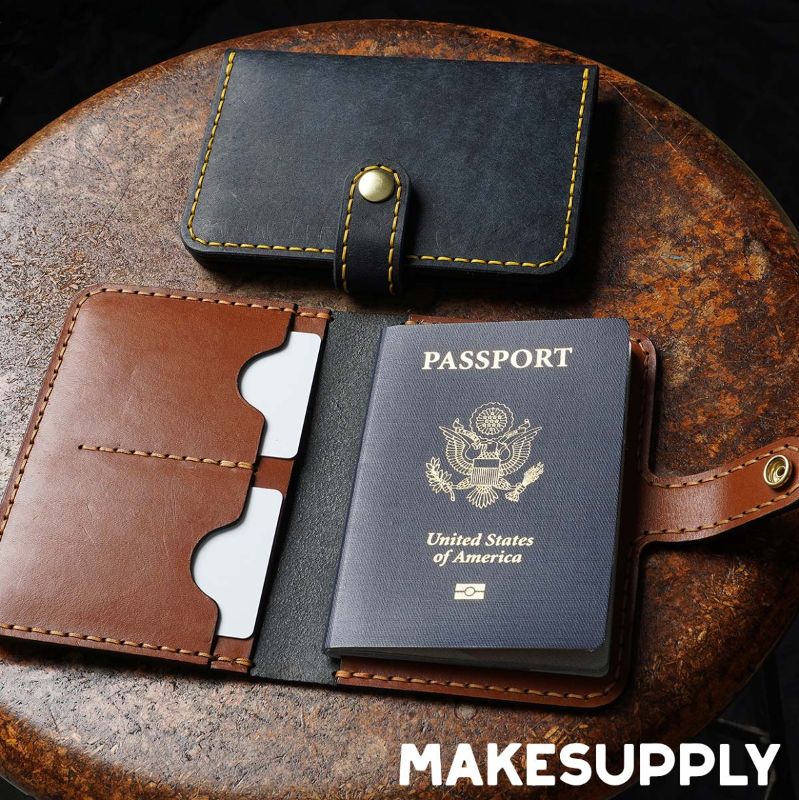 Open leather passport cover with card slots and snap closure holding a US passport, handmade travel wallet