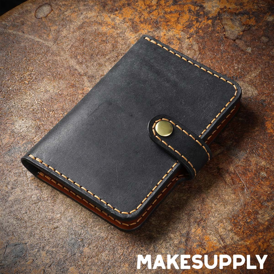 Closed handmade leather passport cover with snap button closure, minimalist travel wallet design