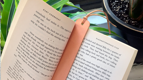 a leather bookmark made from a free PDF pattern in a book
